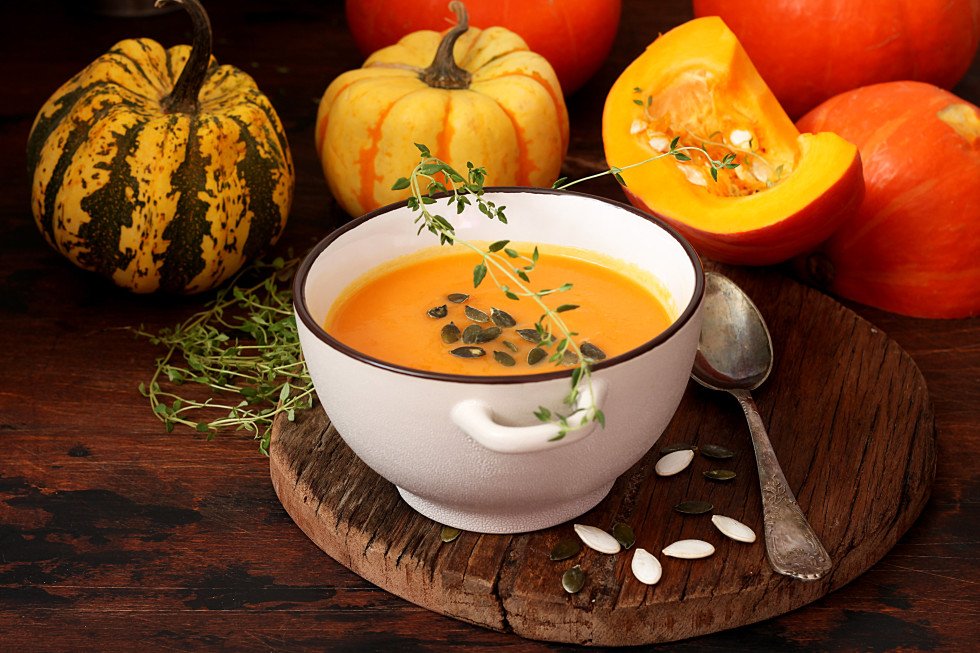 Pumpkin soup with pumpkins in the background